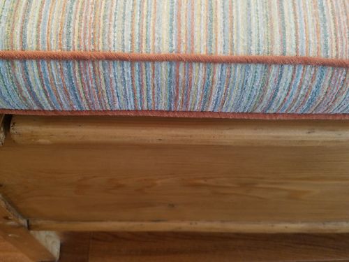 close up stripe cushion with orange piping