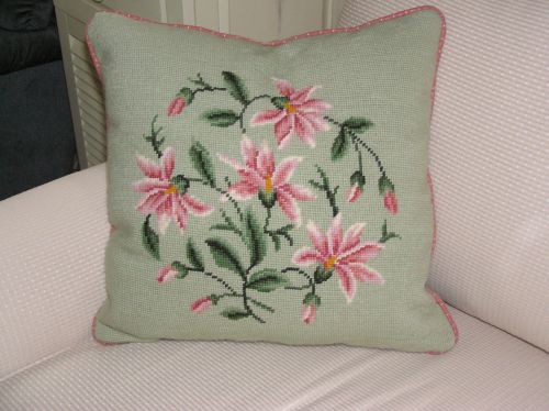 pink and green needlepoint pillow