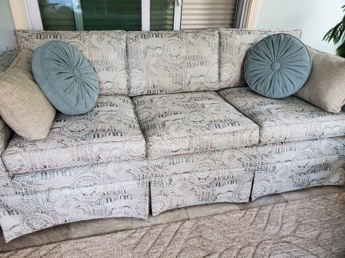 beige sofa slipcover with round pillows